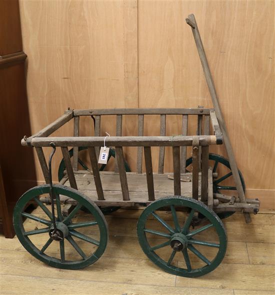 A Victorian wooden four wheel cart with slatted sides W.70cm